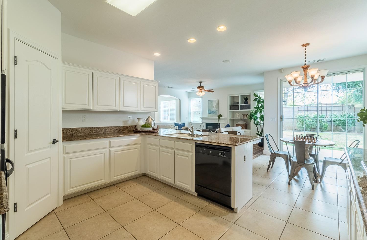 2595 Powers Avenue Coalinga, CA 93210 - Photo 13 of 34 a kitchen with a sink and chairs
