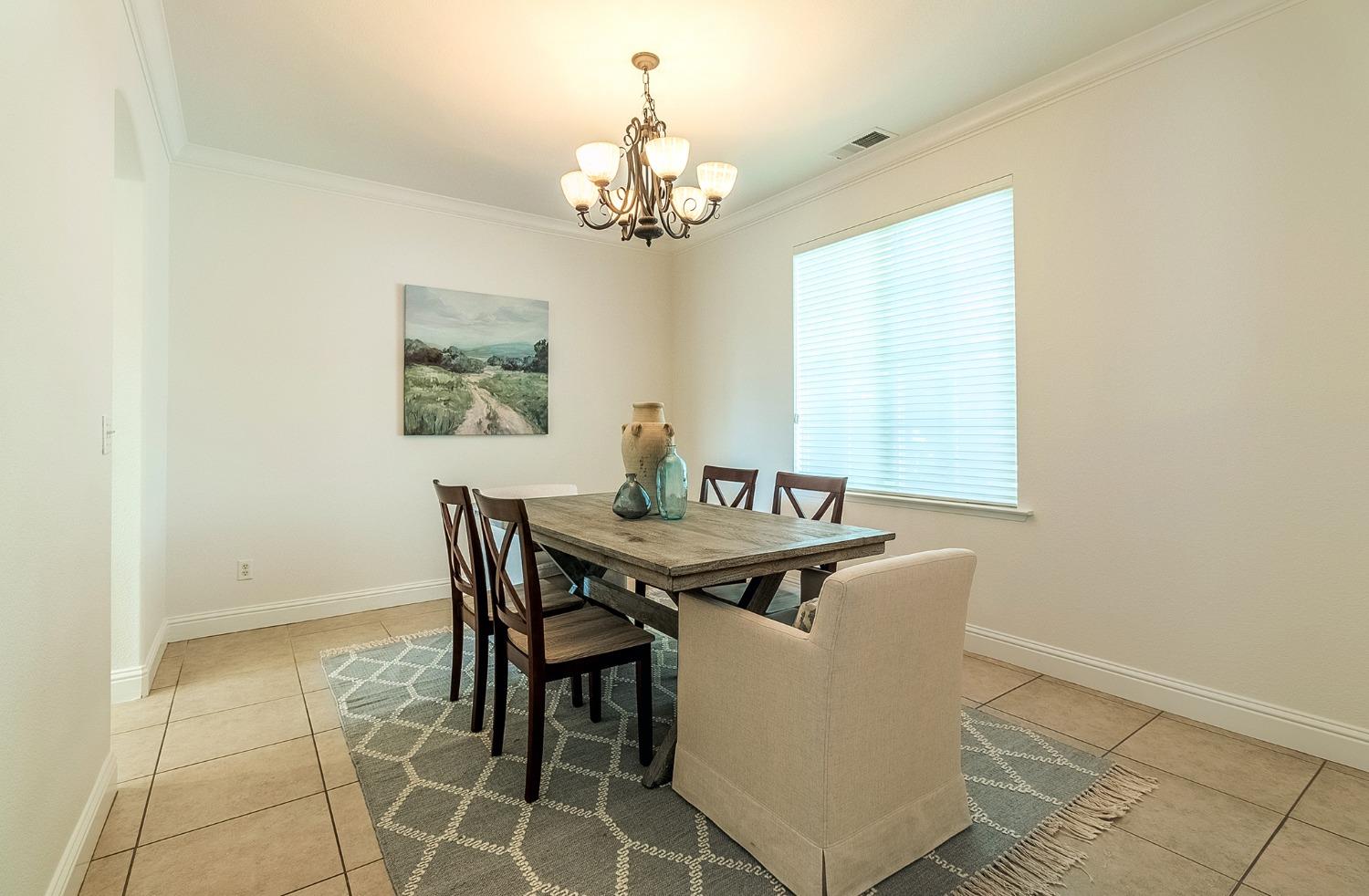 2595 Powers Avenue Coalinga, CA 93210 - Photo 15 of 34 a dining room with furniture and chandelier