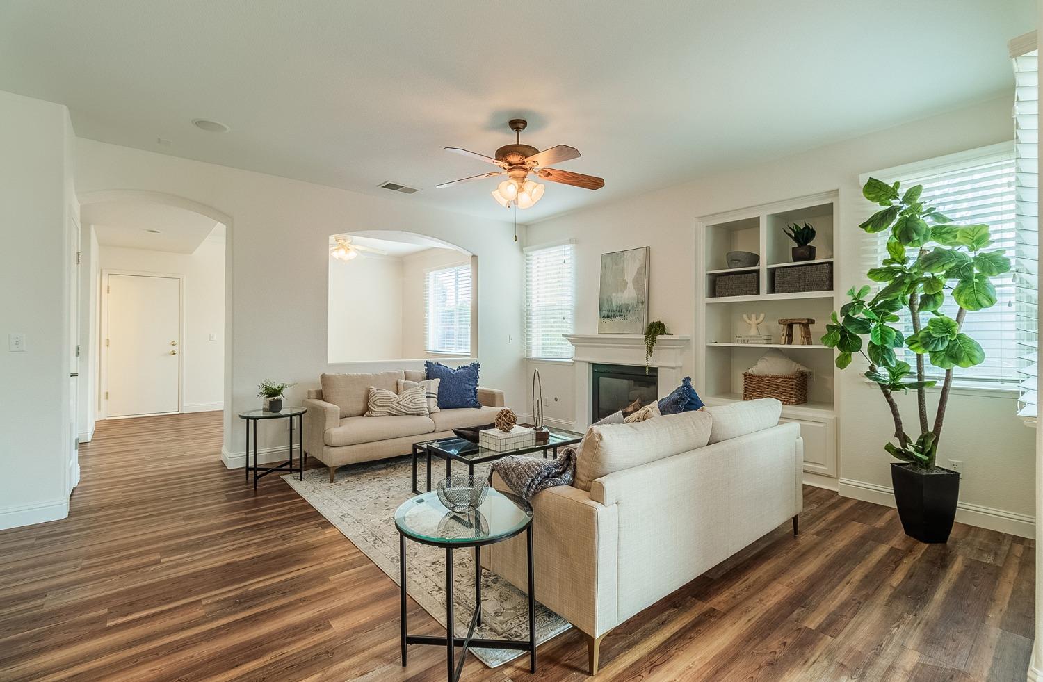 2595 Powers Avenue Coalinga, CA 93210 - Photo 17 of 34 a living room with fireplace furniture and a potted plant