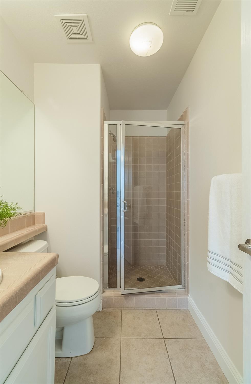 2595 Powers Avenue Coalinga, CA 93210 - Photo 21 of 34 a bathroom with a shower a toilet and a sink