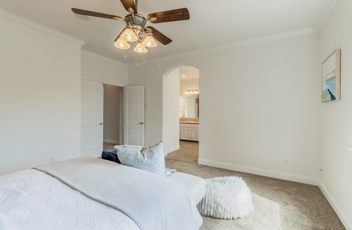 2595 Powers Avenue Coalinga, CA 93210 - Photo 25 of 34 a bedroom with a bed and a chandelier