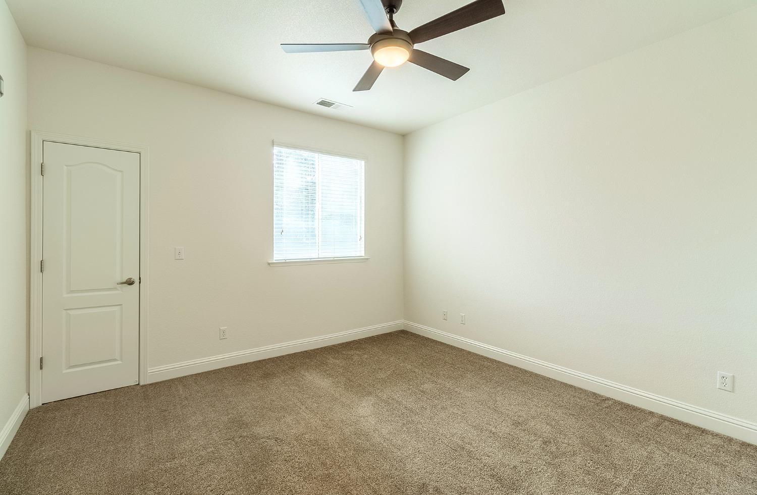 2595 Powers Avenue Coalinga, CA 93210 - Photo 29 of 34 an empty room with a window and a fan