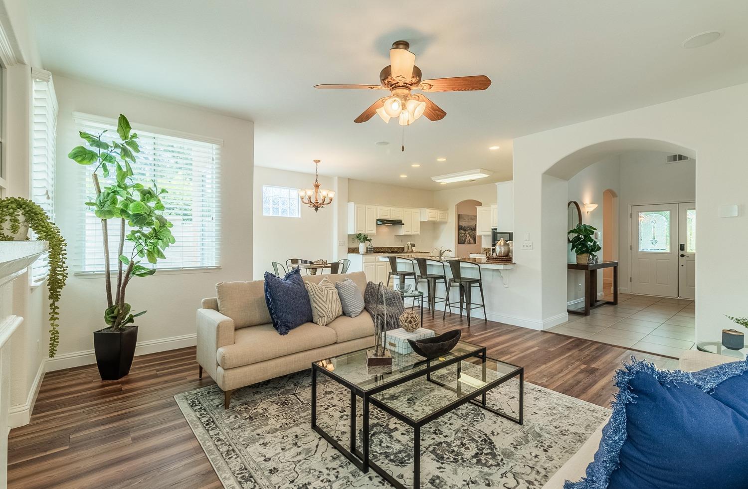2595 Powers Avenue Coalinga, CA 93210 - Photo 7 of 34 a living room with furniture and a chandelier