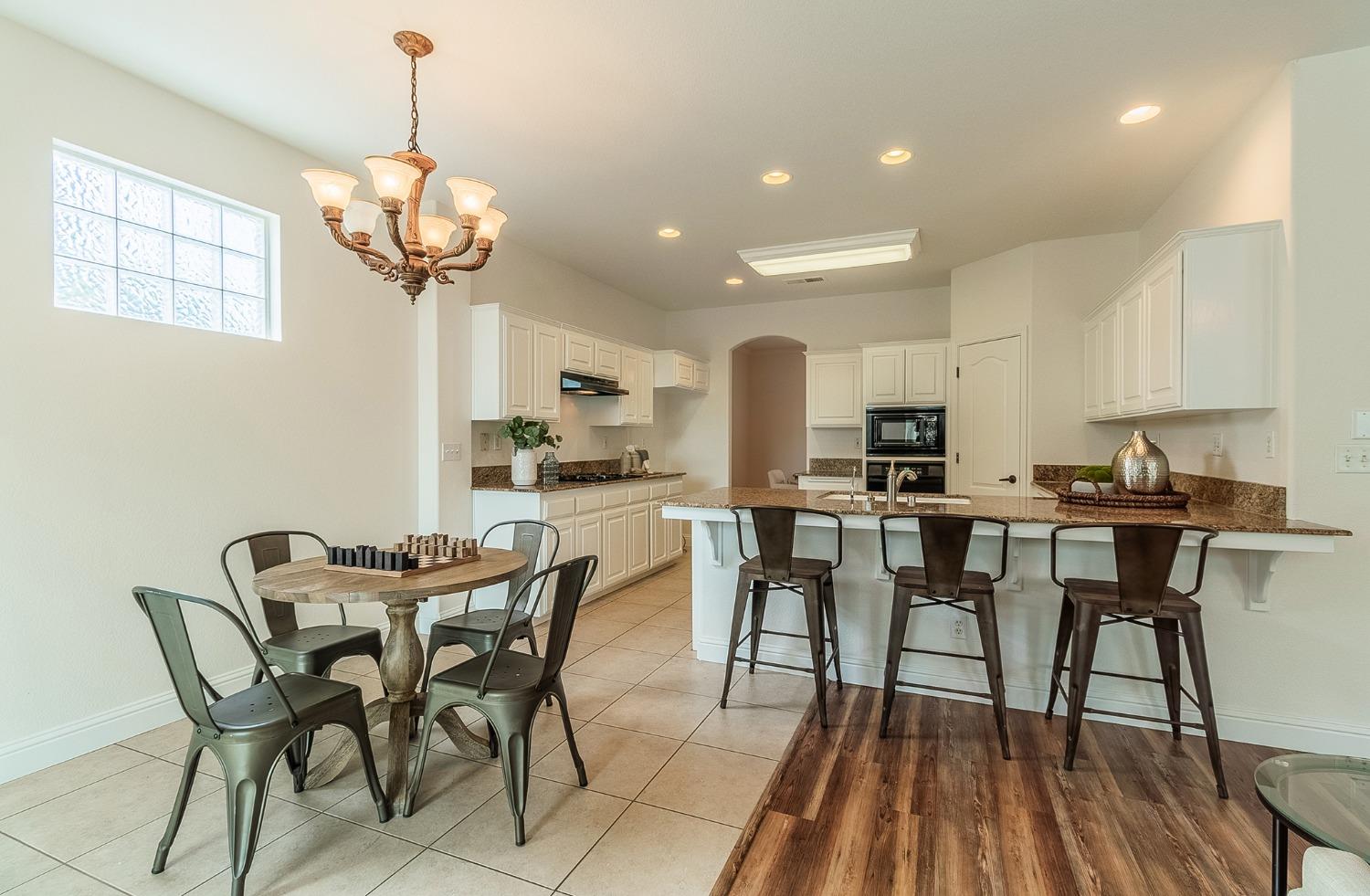 2595 Powers Avenue Coalinga, CA 93210 - Photo 9 of 34 a view of a dining room with furniture wooden floor and chandelier