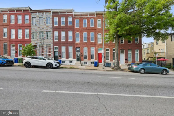 a buildings with car parked in front of it