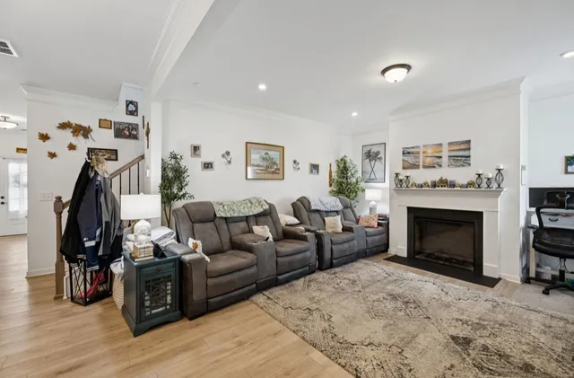 a living room with furniture a rug and a fireplace