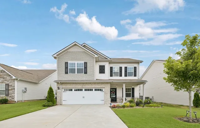 a front view of a house with a yard