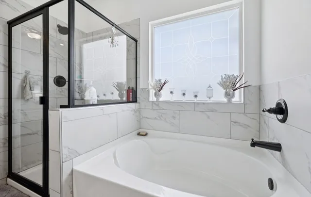 a bathroom with a double vanity sink a mirror and shower