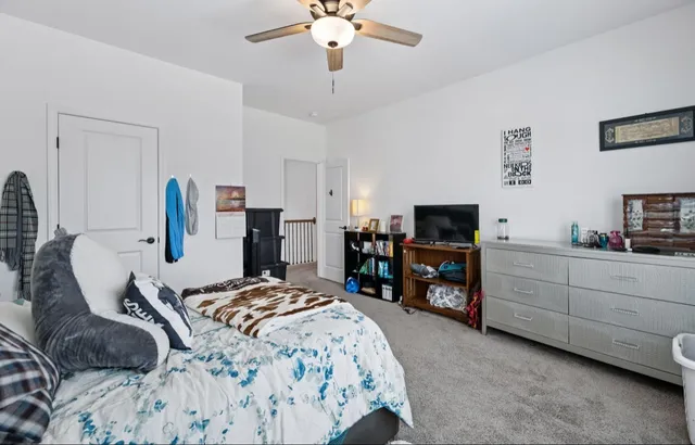 a bedroom with bed and wooden floor