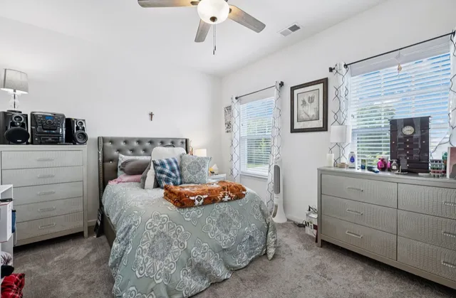 a bedroom with furniture and a chandelier
