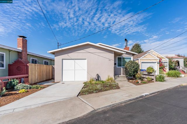 a front view of a house with a yard and potted plants