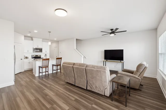 a living room with furniture and a flat screen tv