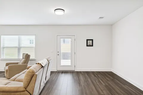 a view of a livingroom with furniture and wooden floor