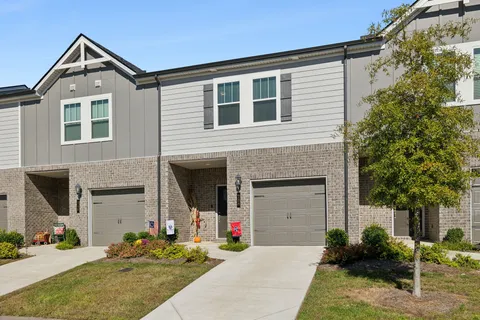 a front view of a house with yard