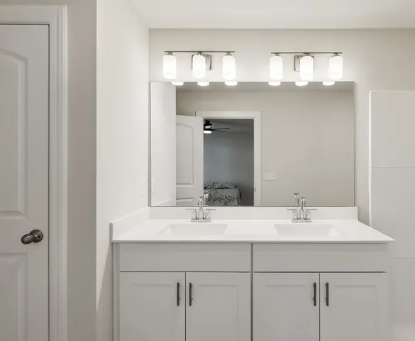 a bathroom with a sink double vanity and a mirror