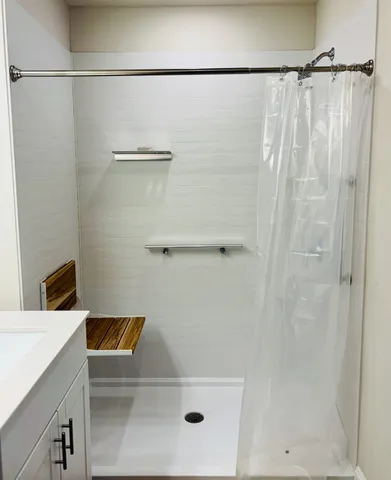 a bathroom with a shower and a sink