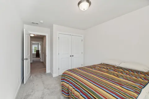 a bedroom with a bed and a mirror