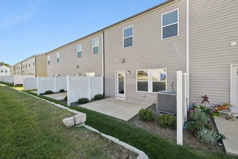 a view of a house with backyard and garden