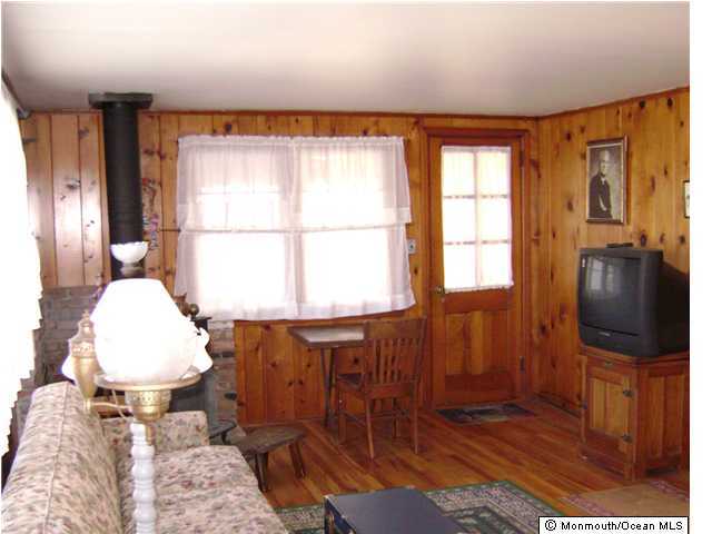 37 Fishermans Road Lavallette, NJ 08735 - Photo 3 of 3 a living room with furniture a flat screen tv and a window