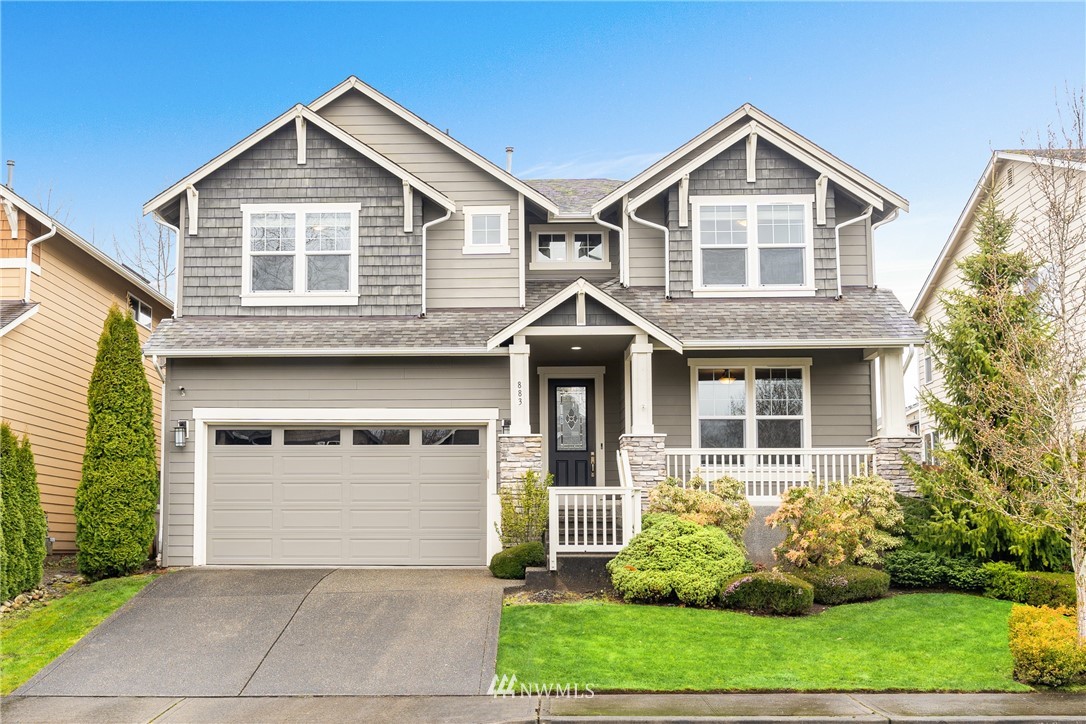 883 Jericho Place Northeast Renton, WA 98059 - Photo 1 of 30 a front view of a house with garden