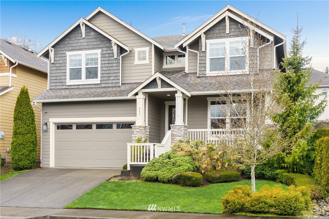 883 Jericho Place Northeast Renton, WA 98059 - Photo 2 of 30 a front view of a house with a yard and trees