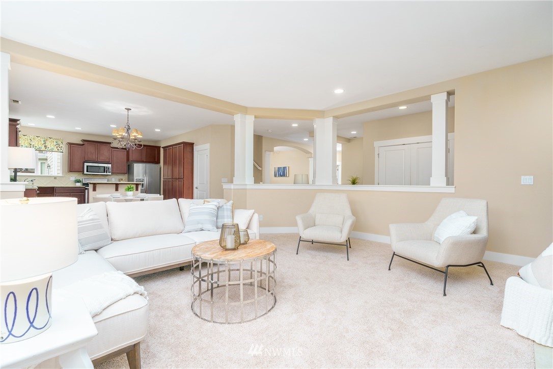 883 Jericho Place Northeast Renton, WA 98059 - Photo 14 of 30 a living room with furniture and a dining table with kitchen view