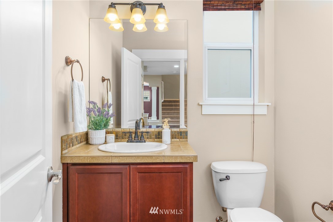 883 Jericho Place Northeast Renton, WA 98059 - Photo 17 of 30 a bathroom with a toilet sink and mirror