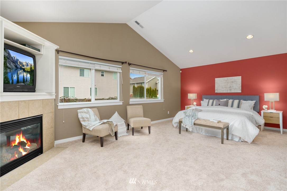 883 Jericho Place Northeast Renton, WA 98059 - Photo 18 of 30 a bedroom with furniture and a fireplace