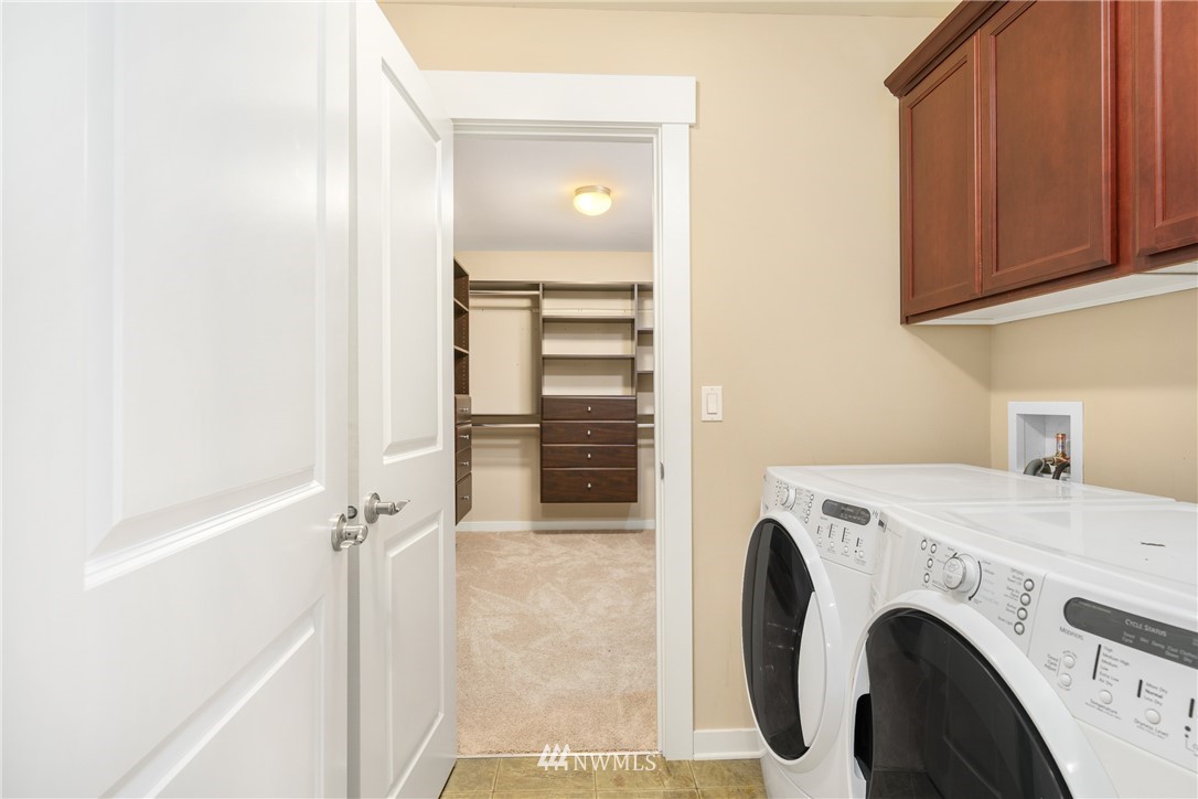 883 Jericho Place Northeast Renton, WA 98059 - Photo 28 of 30 a view of washer and dryer with kitchen in the background