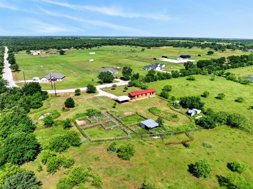 2401 Lamkin Road Mineral Wells, TX 76067 - Photo 5 of 36 a view of a garden with a building in the background