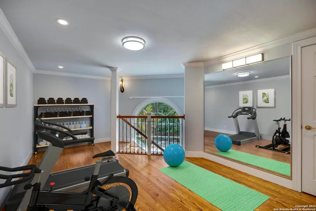 a view of a room with wooden floor door and windows
