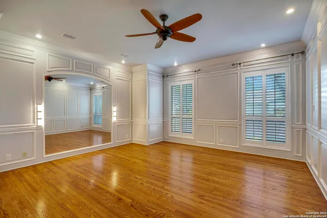 a bathroom with a granite countertop sink a mirror and a shower