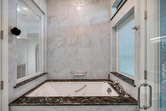 a living room with furniture and large windows