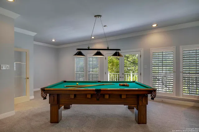 a view of a hallway with wooden floor and a living room