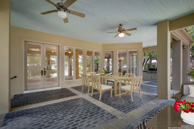 a living room with patio furniture and a large window