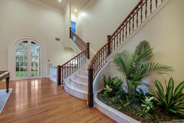 a view of staircase with wooden floor and a potted plant