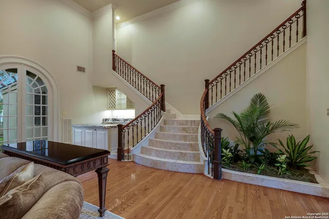 a view of entryway and hall with wooden floor
