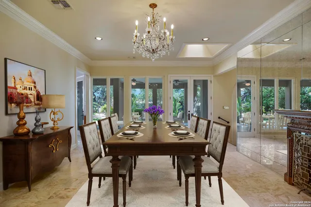 a view of a dining room with furniture wooden floor and chandelier