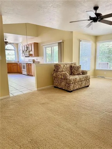 a living room with furniture and chandelier