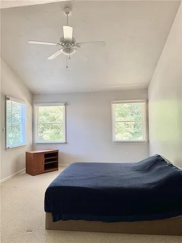 a bedroom with a bed and window