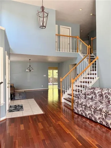 a view of entryway and hall with wooden floor