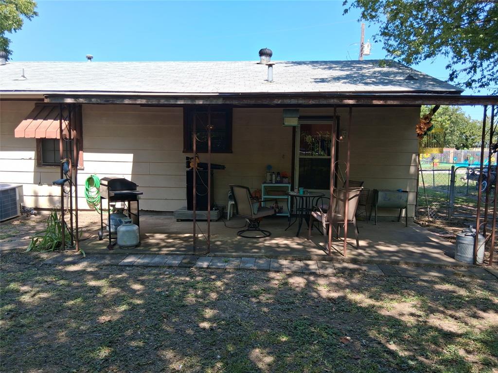 407 North Files Street Itasca, TX 76055 - Photo 25 of 30 Rear view of property with a patio area