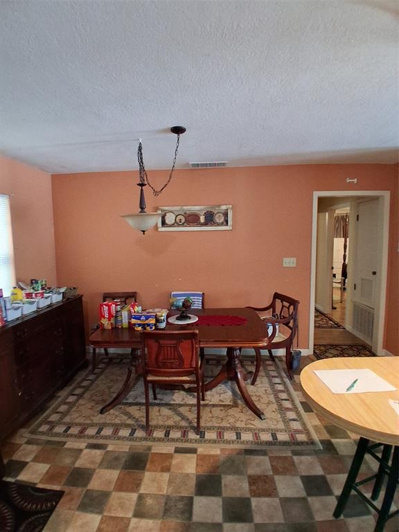407 North Files Street Itasca, TX 76055 - Photo 5 of 30 Dining space with a textured ceiling