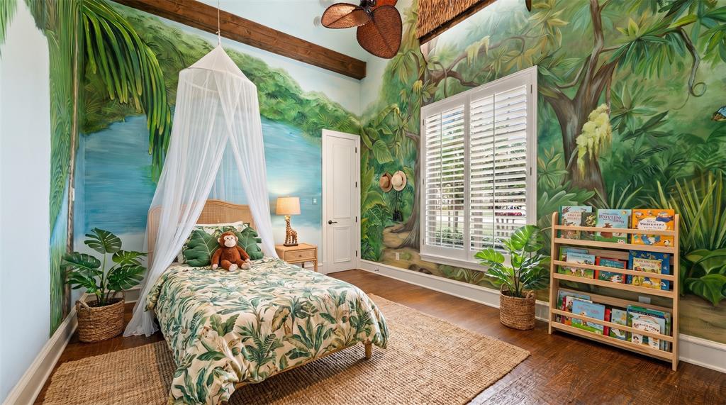 6900 Rockingham Court Colleyville, TX 76034 - Photo 17 of 40 Room featuring detailed wall murals, wood-finish flooring, a white window with plantation shutters, a solid white door, and exposed ceiling beams. Ai staged.