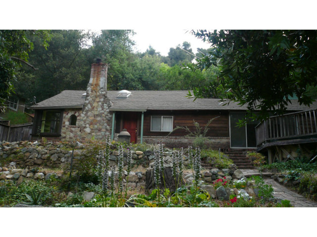 a view of a house with a yard and sitting area