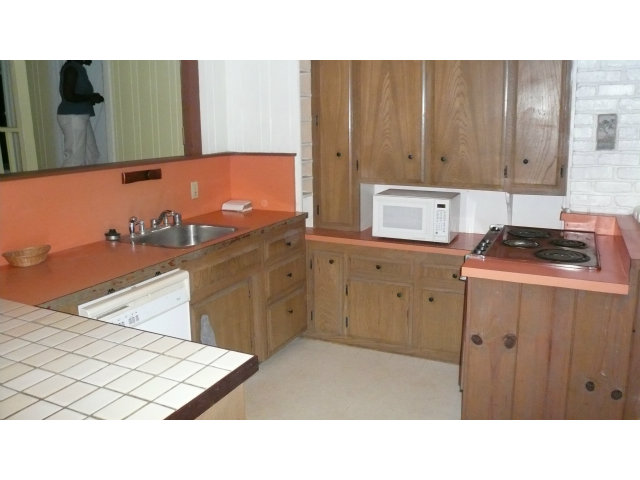 21394 Aldercroft Heights Road Los Gatos, CA 95033 - Photo 4 of 15 a kitchen with a sink window and cabinets