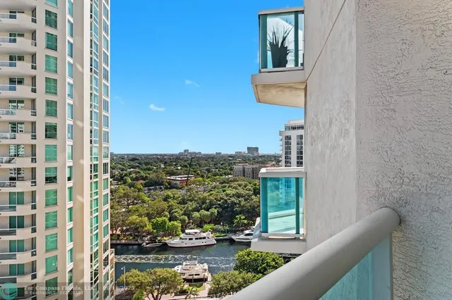 a view of a balcony with chairs and a potted plant