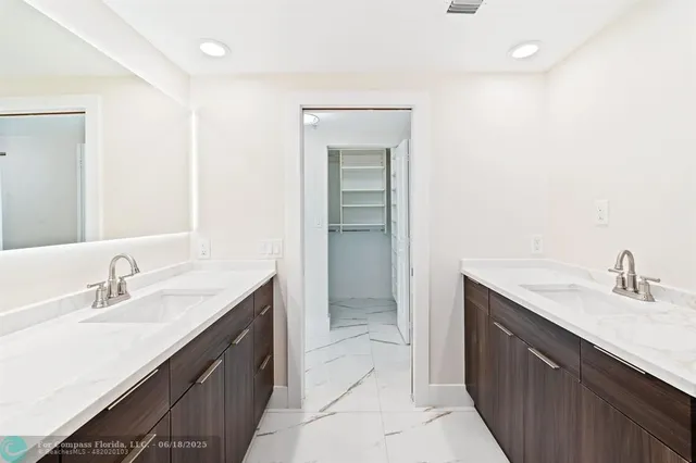 a bathroom with a sink double vanity and a mirror