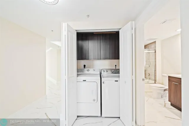 a bathroom with a double vanity sink toilet and shower
