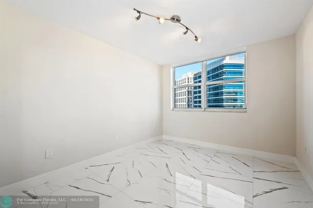 a view of a kitchen with refrigerator and mirror